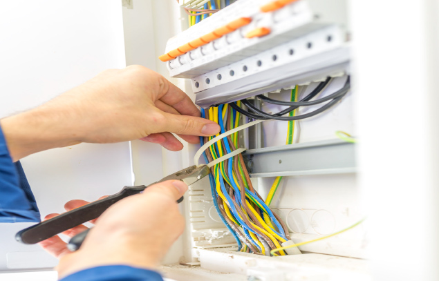 Electrician wiring a domestic consumer unit